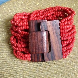 Orange beaded bracelet with wood closure